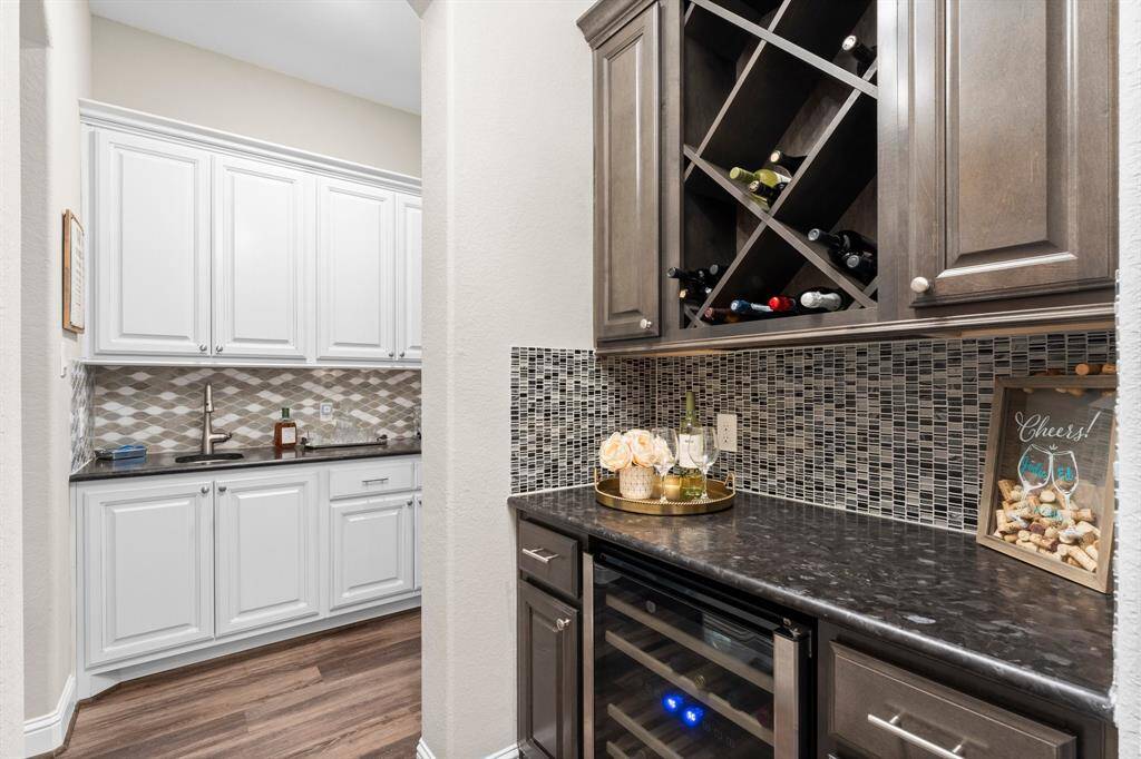 Beautiful wood cabinetry showcases your wine collection or chilled to perfection in the built-in wine refrigerator.
