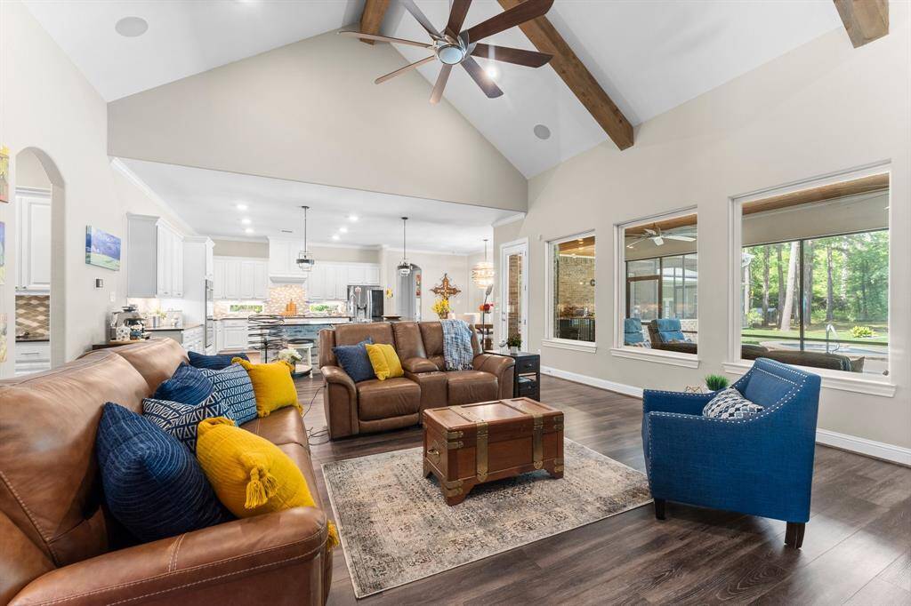 Expansive windows flood the space with natural light and offer breathtaking panoramas of your stunning backyard oasis and sparkling pool.