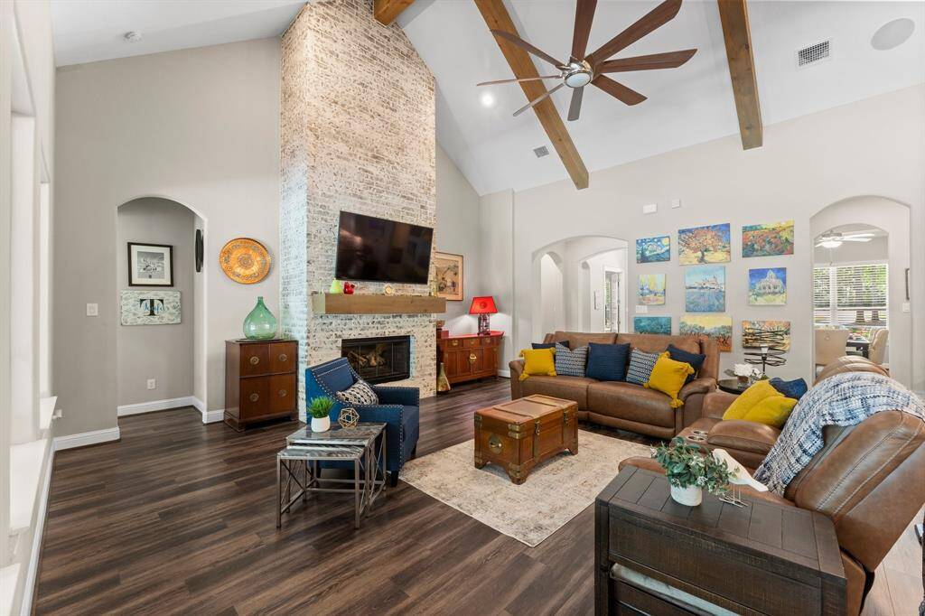 This home features a family room designed for both comfort and style. The breathtaking focal point is a floor-to-ceiling gas log fireplace, adorned with gorgeous brick.