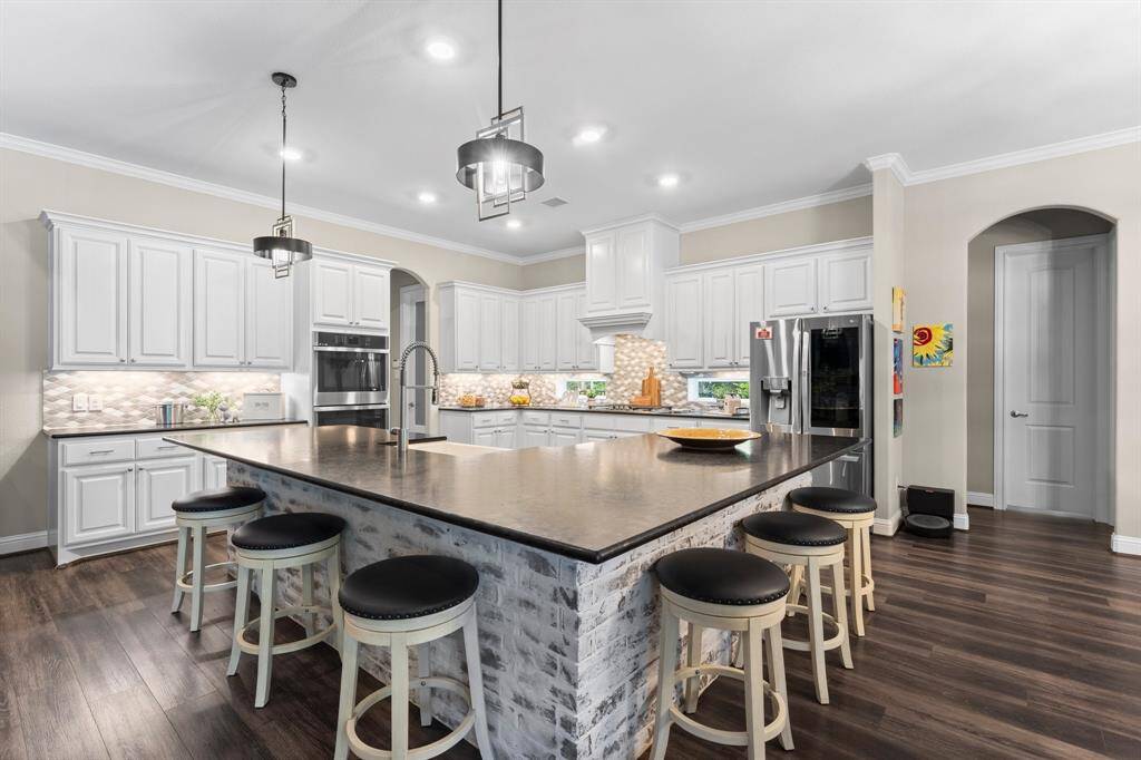 Unleash your inner chef in this expansive kitchen! Boasting generous counter space and abundant upper cabinets, this culinary haven offers all the storage and prep area you could ever desire.