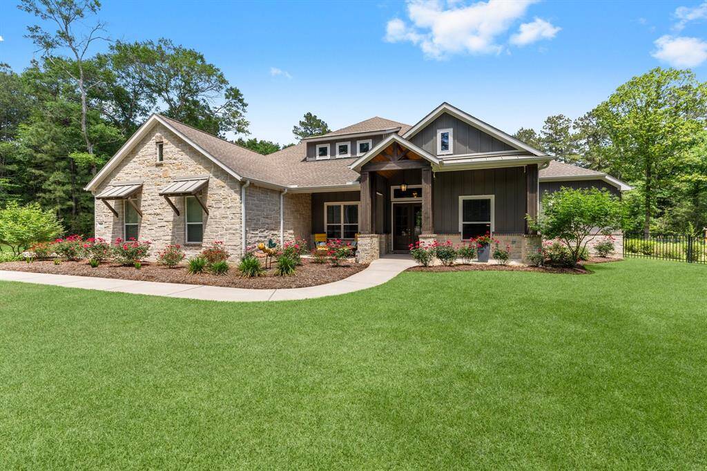 Featuring a striking combination of stone, siding and brick, a welcoming covered front porch, and meticulously maintained landscaping, this property offers an inviting and picturesque first impression.