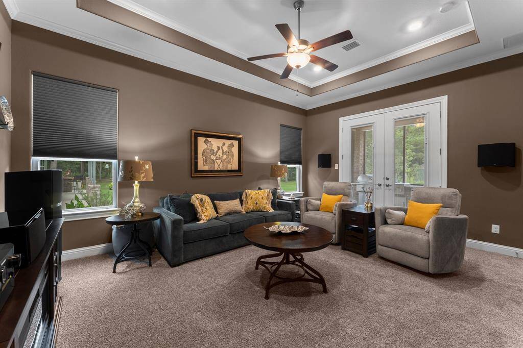 This stunning media/game room/flex space offers endless possibilities, with convenient double door access to the back patio.
