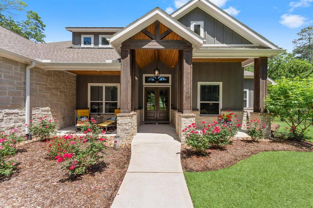 This property boasts a captivating front porch, perfect for unwinding, and a generously sized, covered entry and  inviting double doors.