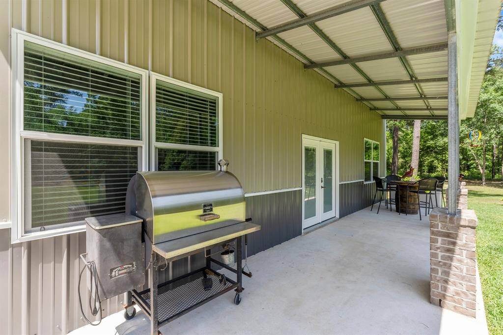 The covered porch of the workshop is a perfect spot to relax, entertain guests, or simply escape the summer heat.