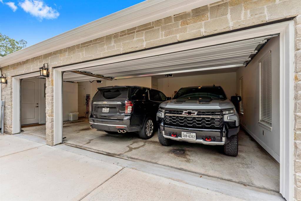 Oversized, attached 3 car garage with extra lighting fits large vehicles and 8 foot trucks! Included in the garage is a 30-Amp Electric Vehicle Charging Station!