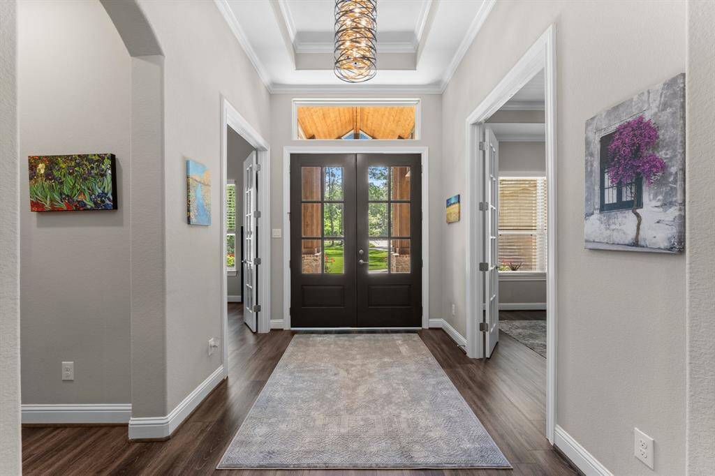 A view of the entry from inside the home with plenty of natural light shining through the double front doors.