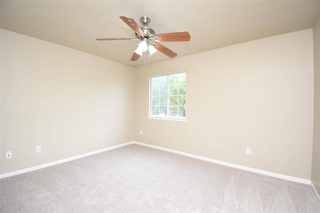 Check out this cozy bedroom with a ceiling fan and perfect natural light from the window. Where comfort meets design!
