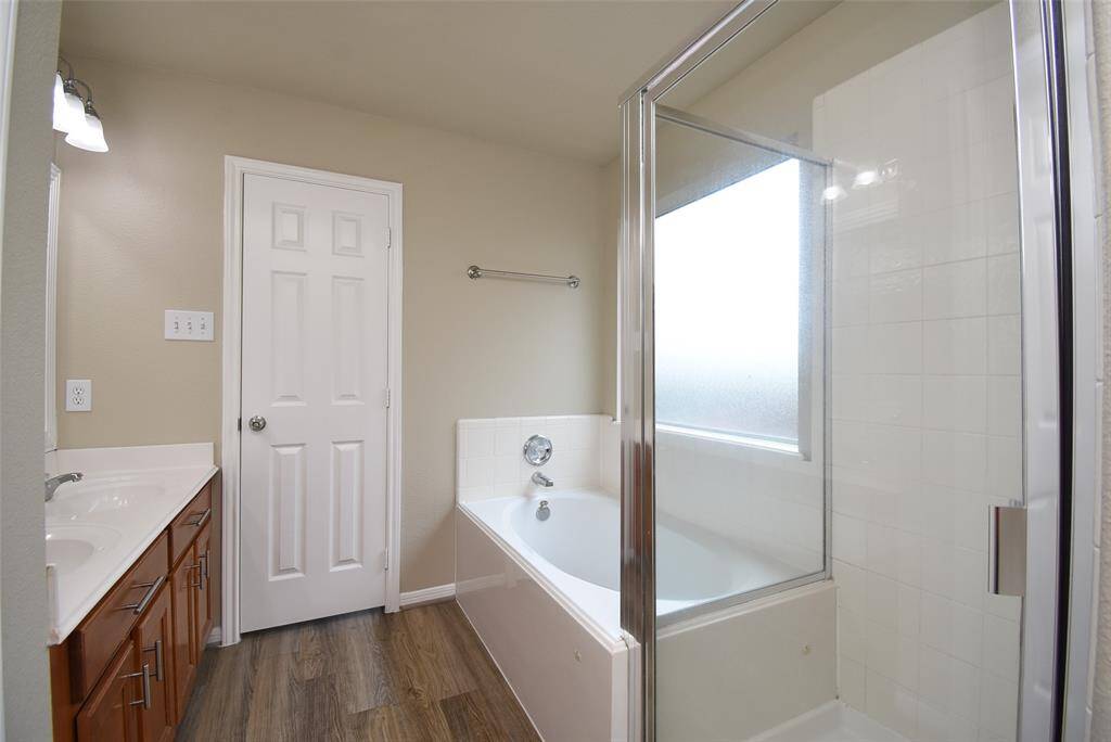 Elevate your daily routine in this chic primary bath! From the stylish tub to the sleek sink, every detail is designed for relaxation and rejuvenation