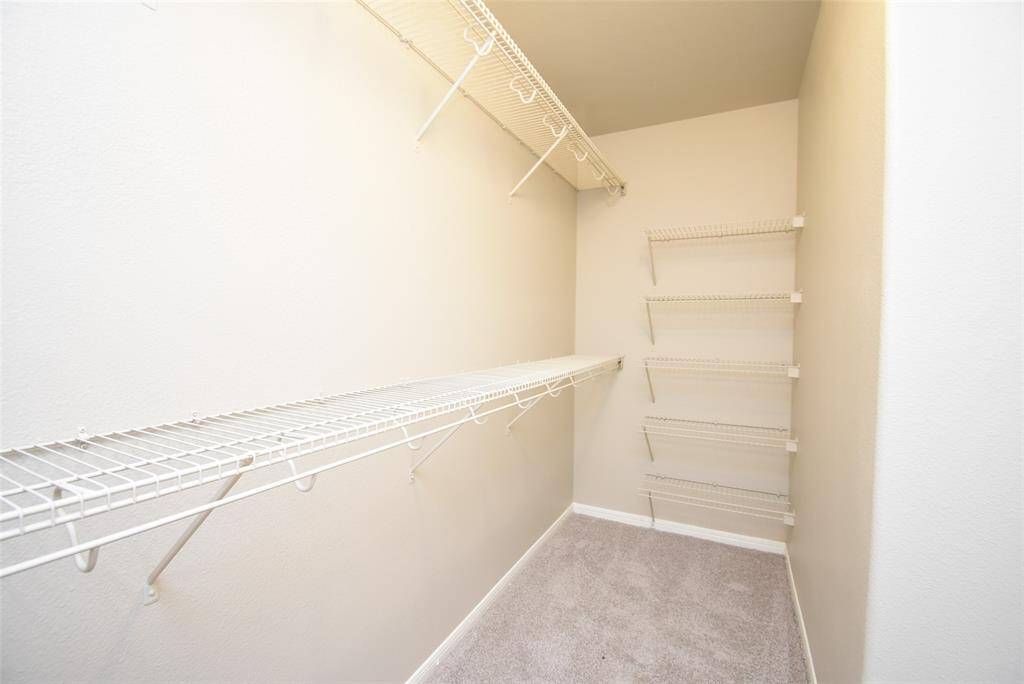 This spacious walk-in closet offers plenty of storage with built-in shelving and hanging space—perfect for keeping everything organized and within reach!