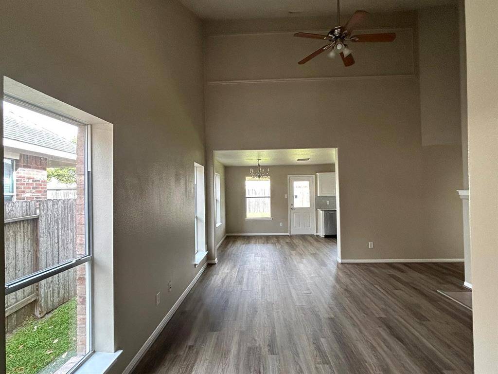 Chillin' in this cozy room with the perfect blend of wood floors and a stylish ceiling fan. Let the daylight flood in and vibes flow out!