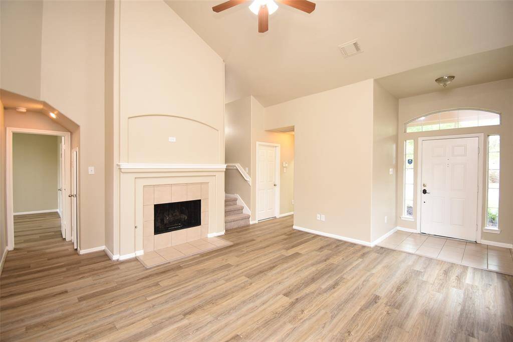 This family room exudes comfort with its beautiful wood floors and cozy fireplace—perfect for relaxing on chilly nights!