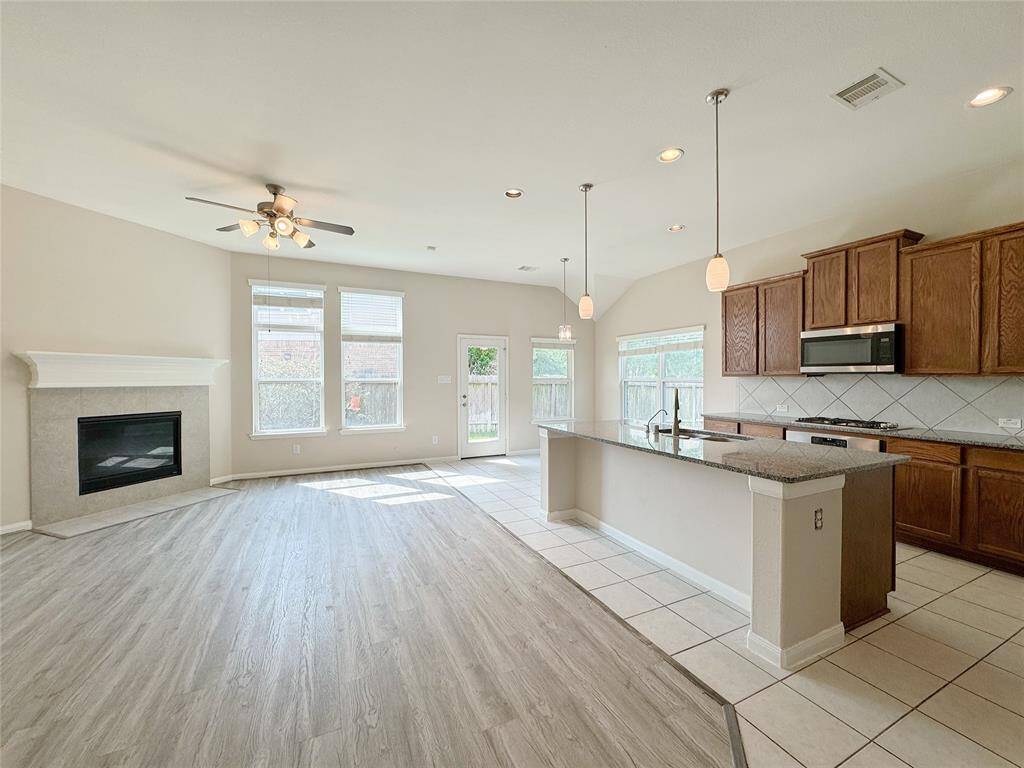 Living room with ceiling fan and fireplace