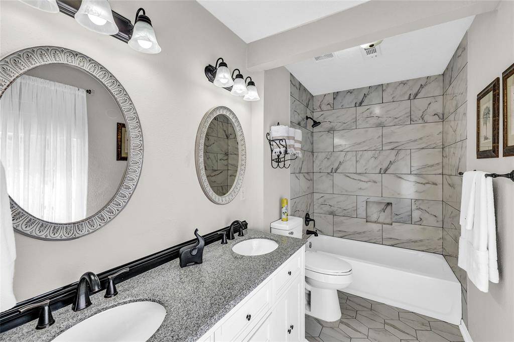Primary Bathroom - completed remodeled with new sinks, tub / shower, mirrors and fixtures.