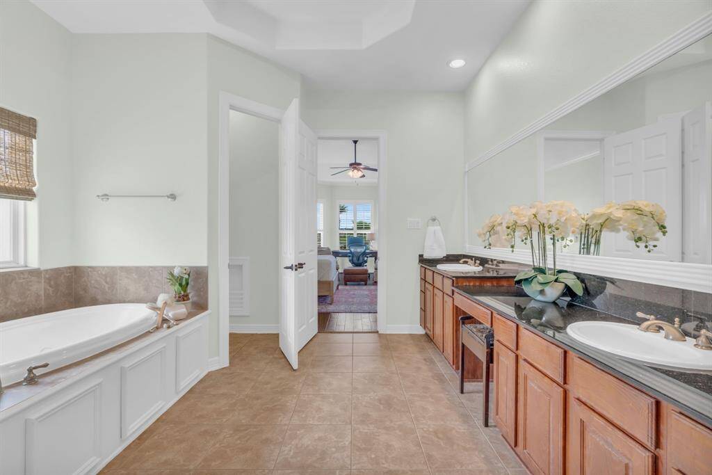 The Ensuite Bath has granite countertops, dual sinks & a vanity, a soaking garden tub & tile flooring! 27103 Boater's Crossing Dr., Katy, TX  77493