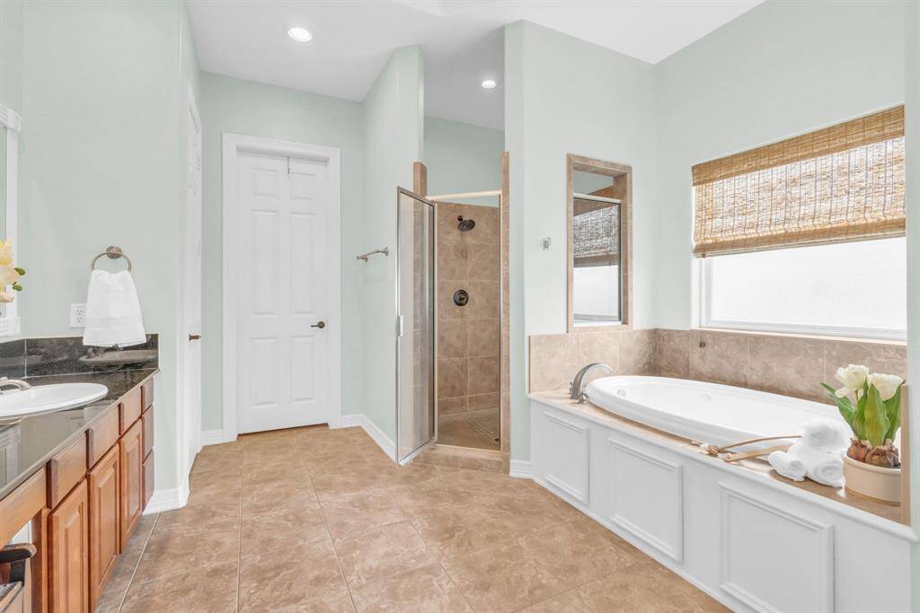 The Ensuite has a soaking garden tub, walk-in shower & tile flooring! 27103 Boater's Crossing Dr., Katy, TX  77493