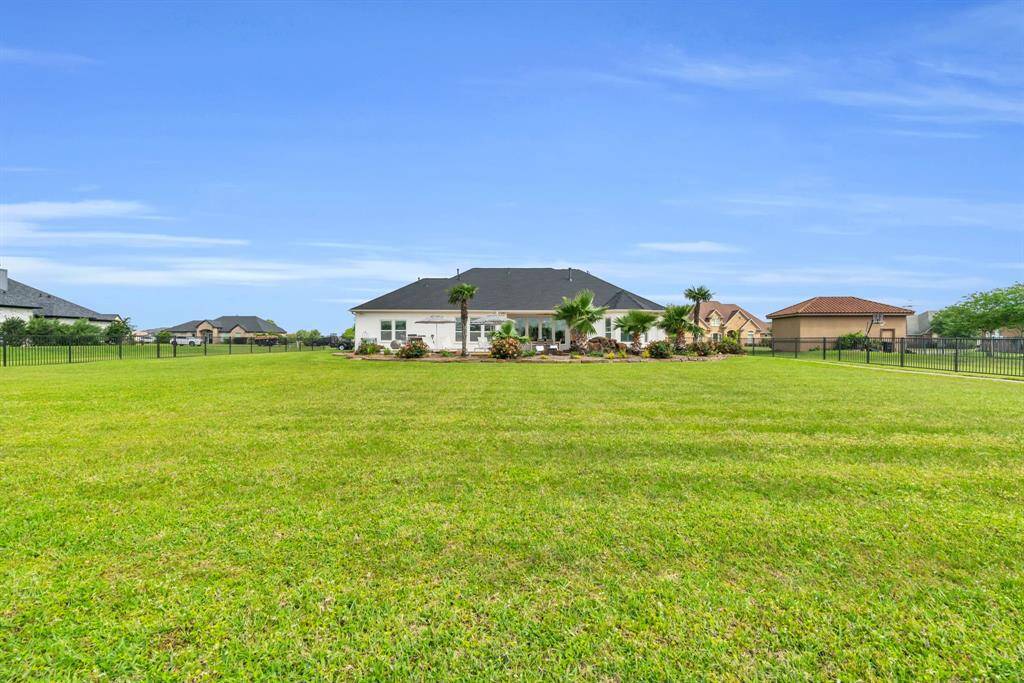 Take a look at this Backyard Space fenced in with a wrought iron gate! 27103 Boater's Crossing Dr., Katy, TX  77493