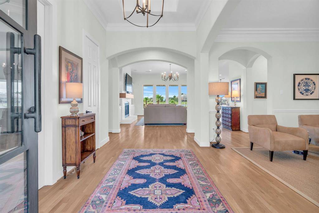 Grand Entry featuring Tiered Coffered Ceilings, Elegant Chandelier & Wood Flooring found throughout the 1st Floor! 27103 Boater's Crossing Dr., Katy, TX  77493