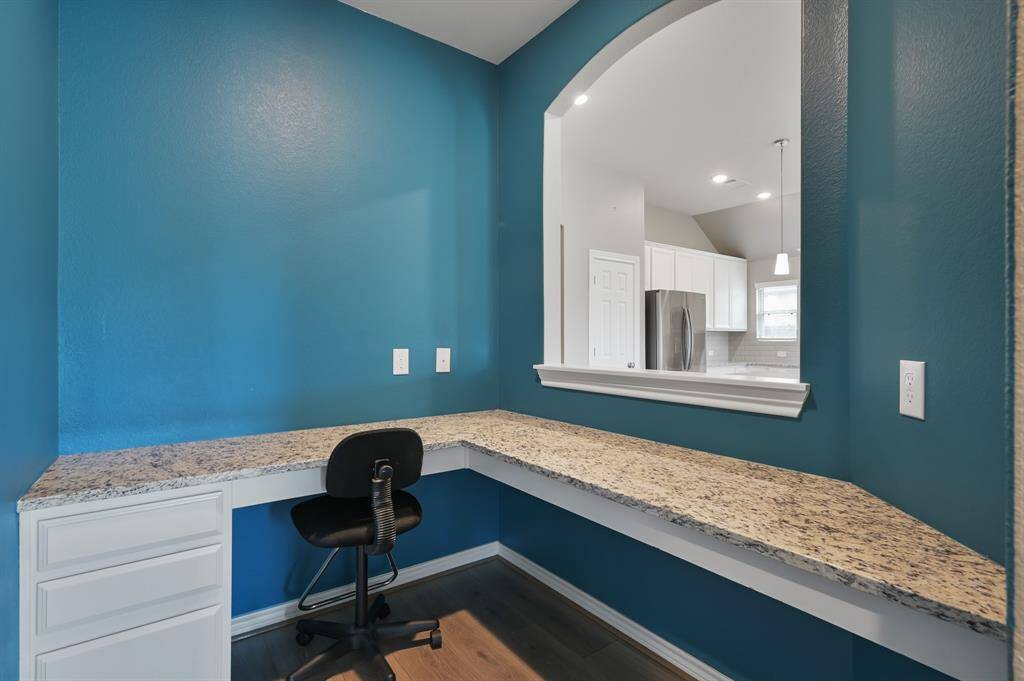 Directly across from the living room and kitchen, sits an office space with drawers and plenty of room for addiitonal storage build-outs.