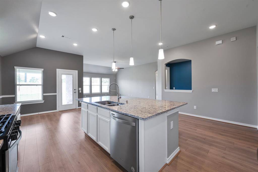 Plenty of counter space to prep alongside your gas burner stove and large kitchen sink.
