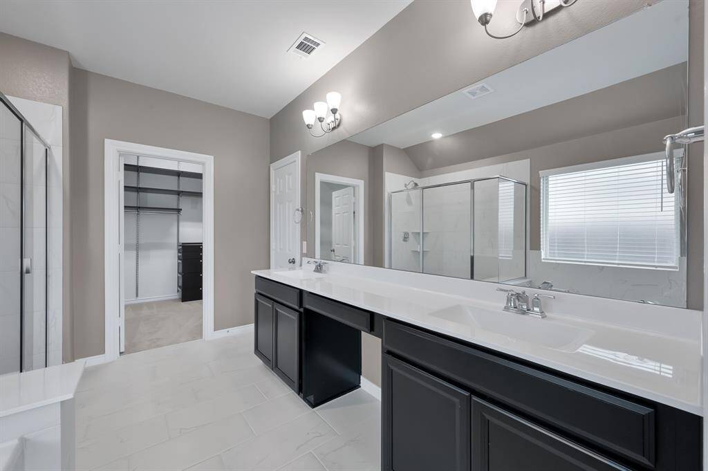 Ensuite bathroom features double sinks and private water closet.