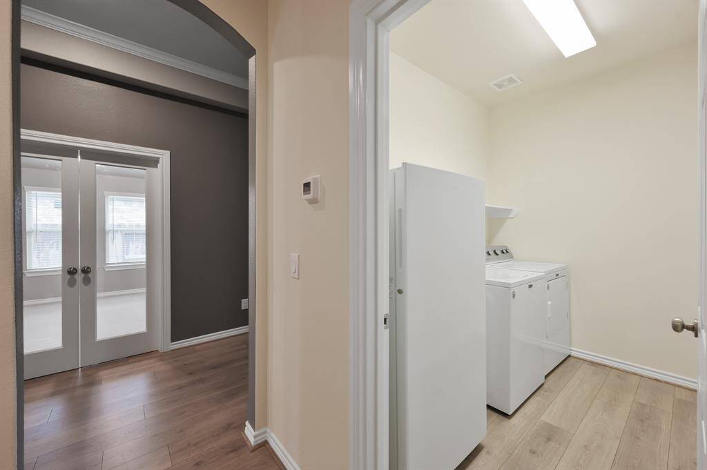 Huge laundry room equipped with washer and dryer electric connections has enough room for additional storage and/or a second refrigerator of general size.