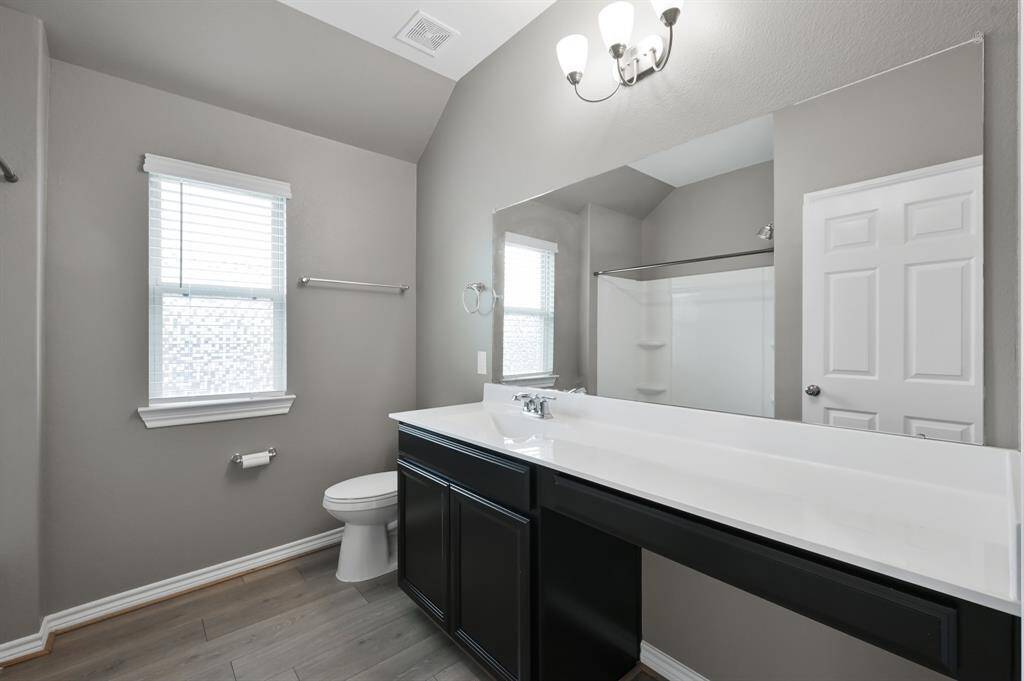 Secondary bathroom is equipped with a large linen closet, vanity seating and shower/tub combo