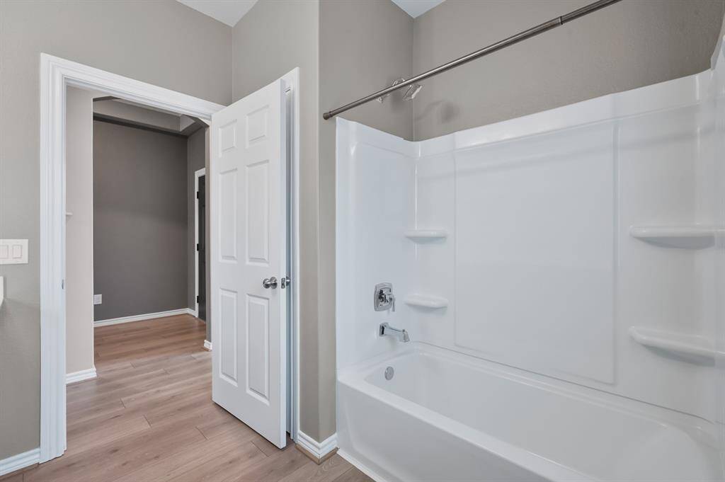 Secondary bathroom is equipped with a large linen closet, vanity seating and shower/tub combo