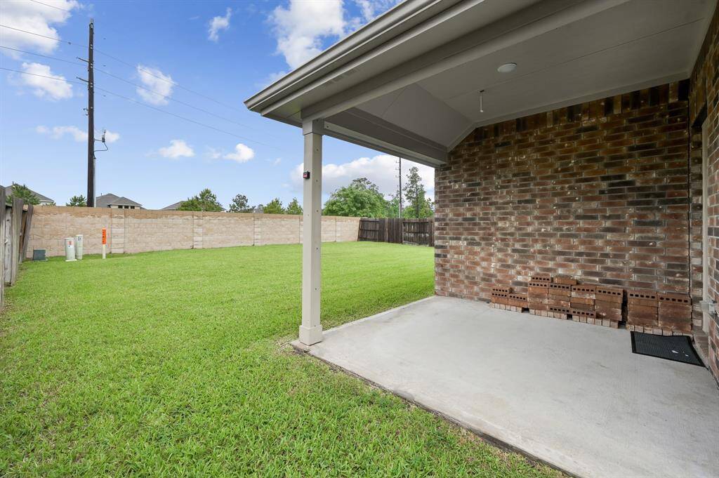 The home's covered patio looks onto the large back yard with NO REAR NEIGHBORS - Plenty of space for entertaining!