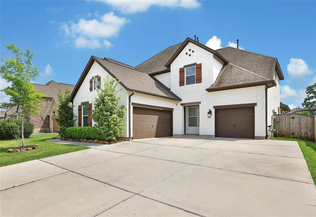Three car garage and oversized driveway.