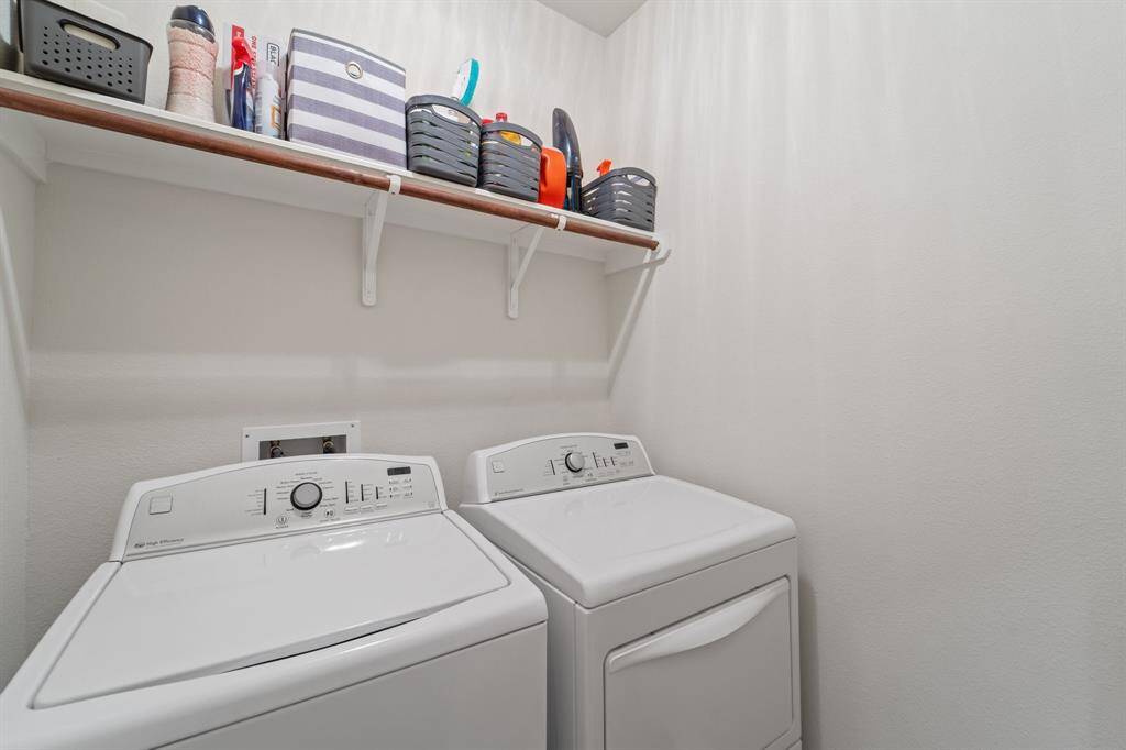 Utility room located within the home with both washer and dryer staying