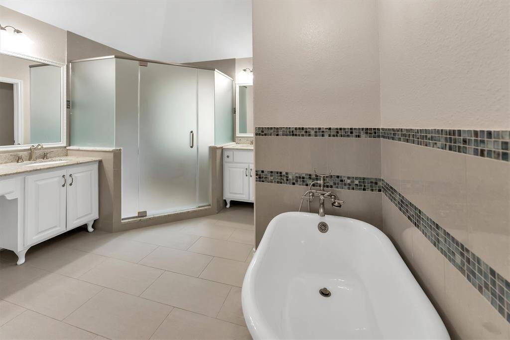 Primary bathroom has been updated with stand alone tub, large walk in shower, dual vanities and walk in closet.