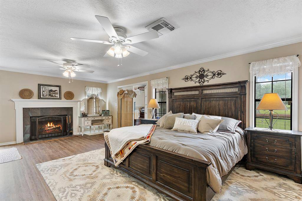The spacious primary bedroom features a cozy fireplace, ideal for relaxation and warmth.