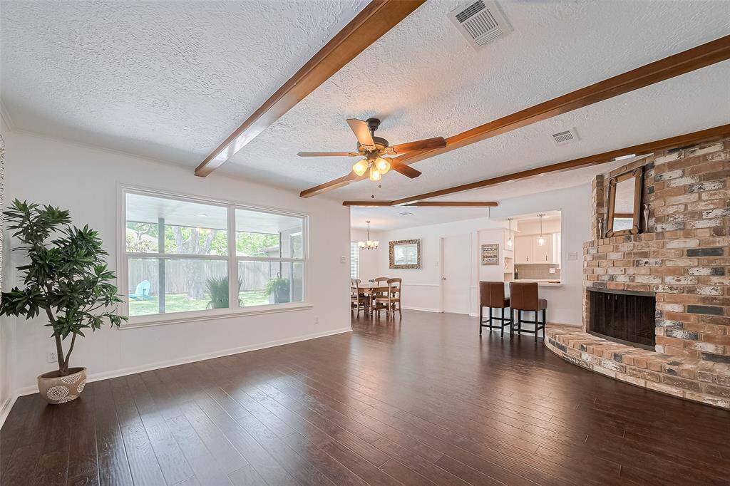 Warm and inviting, this spacious family room boasts a natural brick gas fireplace—perfect for cozy evenings and effortless entertaining.