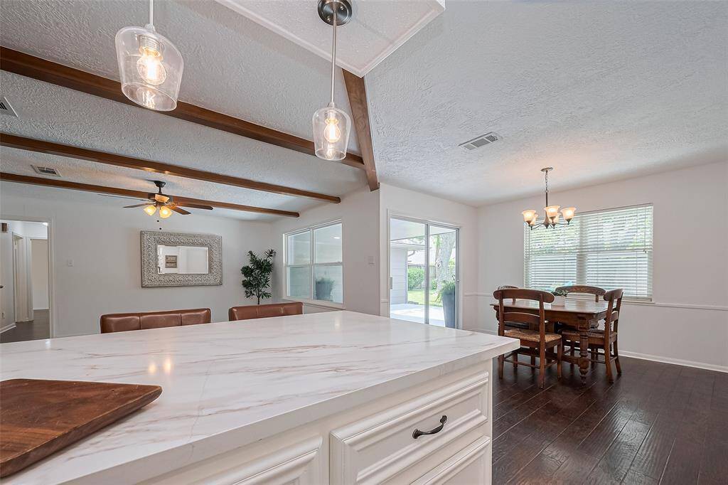 Breakfast bar with open layout, and bright lighting—perfect for both everyday cooking and entertaining.