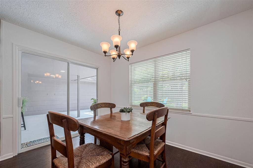 French doors from the breakfast room open to a covered patio, offering a seamless indoor-outdoor living experience