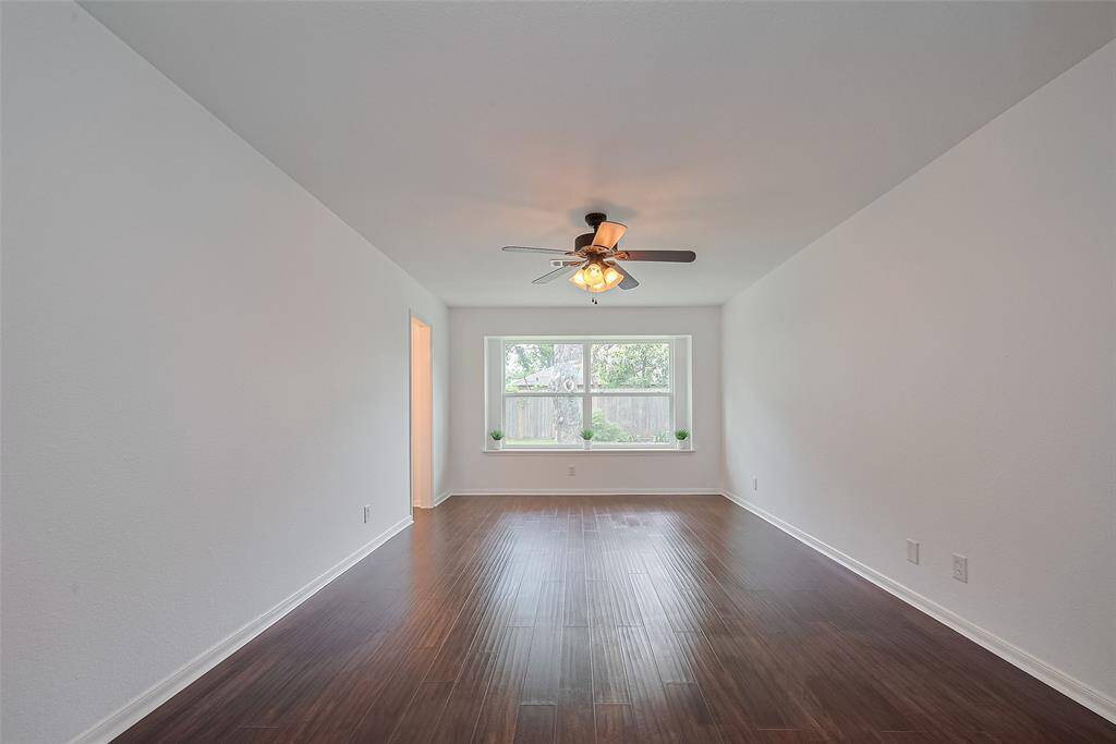 Spacious primary bedroom with views of the tranquil backyard, providing a serene retreat.