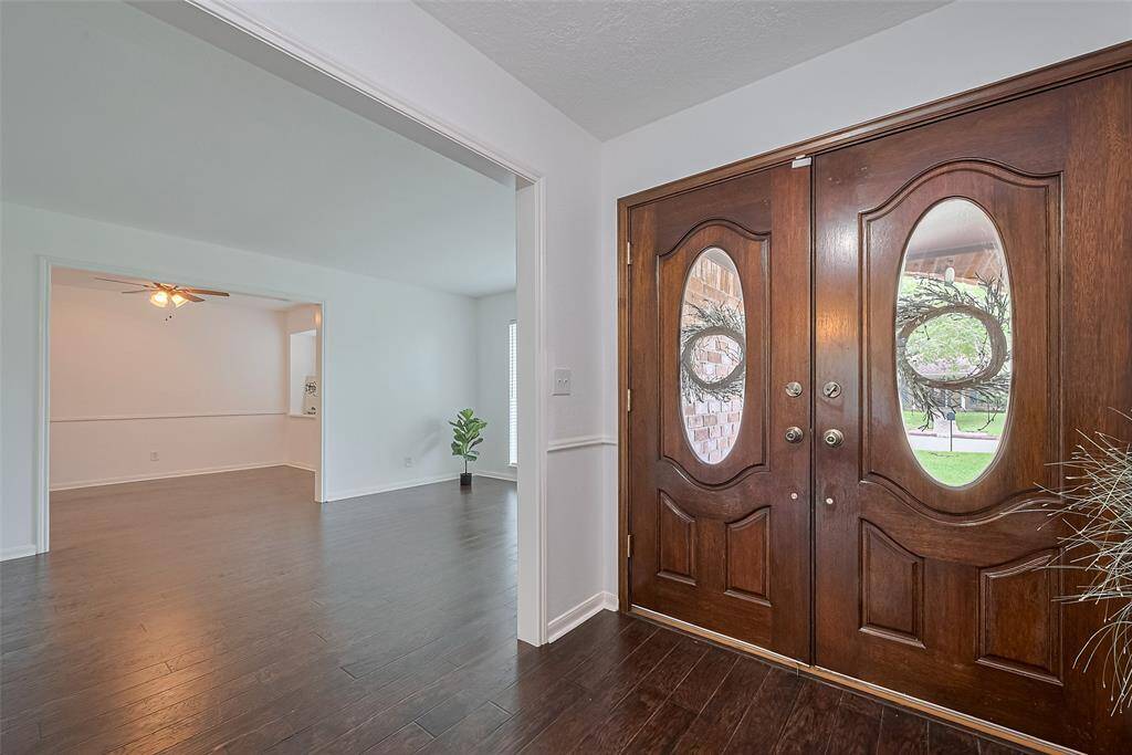 Entryway featuring double doors, creating a warm and elegant first impression