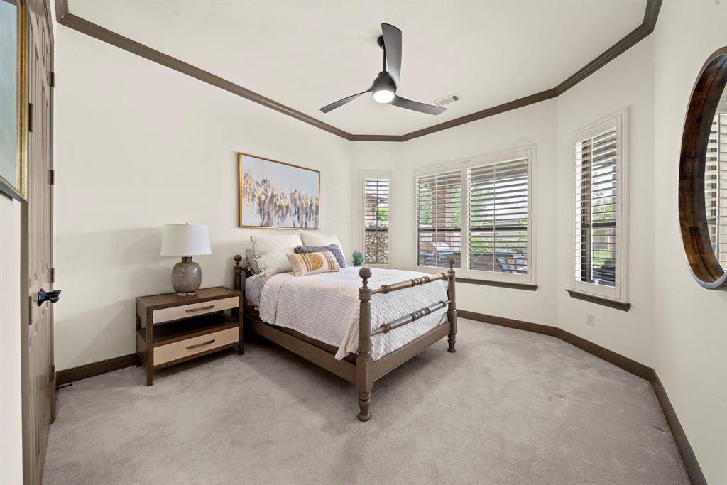 The secondary bedroom down overlooks the backyard oasis, has carpet and high ceilings. Full bath is just outside the door
