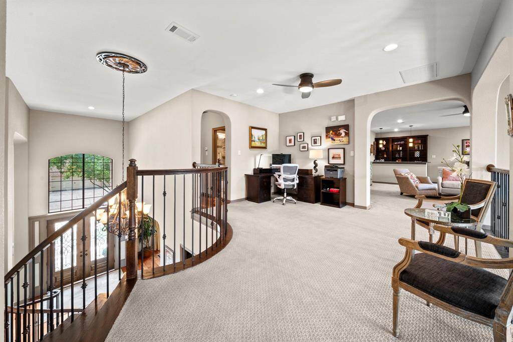 The upstairs landing overlooks the entry and the den and provides space for an upstairs work area or reading nook