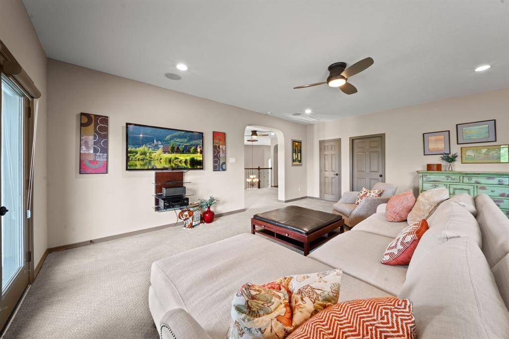 The doors lead to a large game closet and extended floored attic space which could be converted to a media room or used for storage