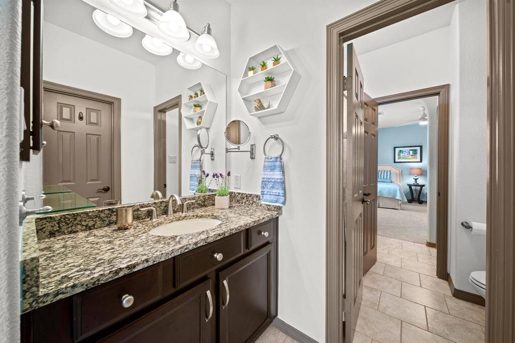 Bathroom 3 upstairs with granite counters, medicine cabinet, tile floors