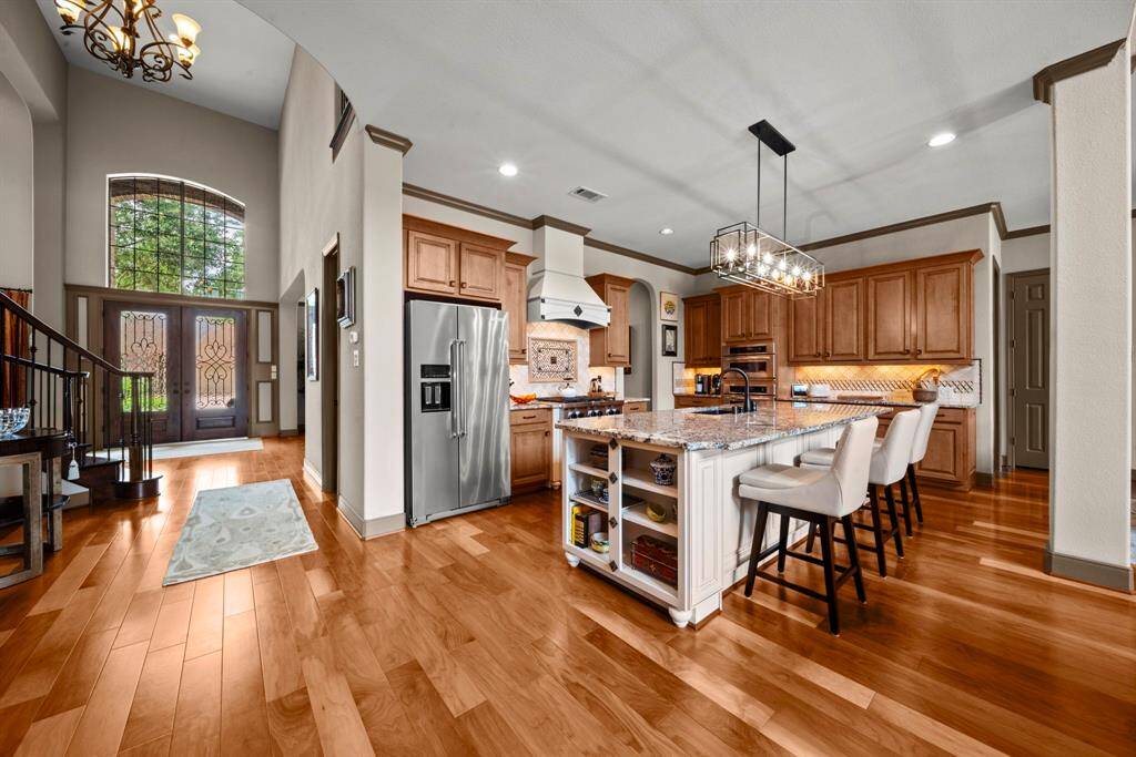 The kitchen is open to the den and has counter seating, granite counters and lots of cabinet space