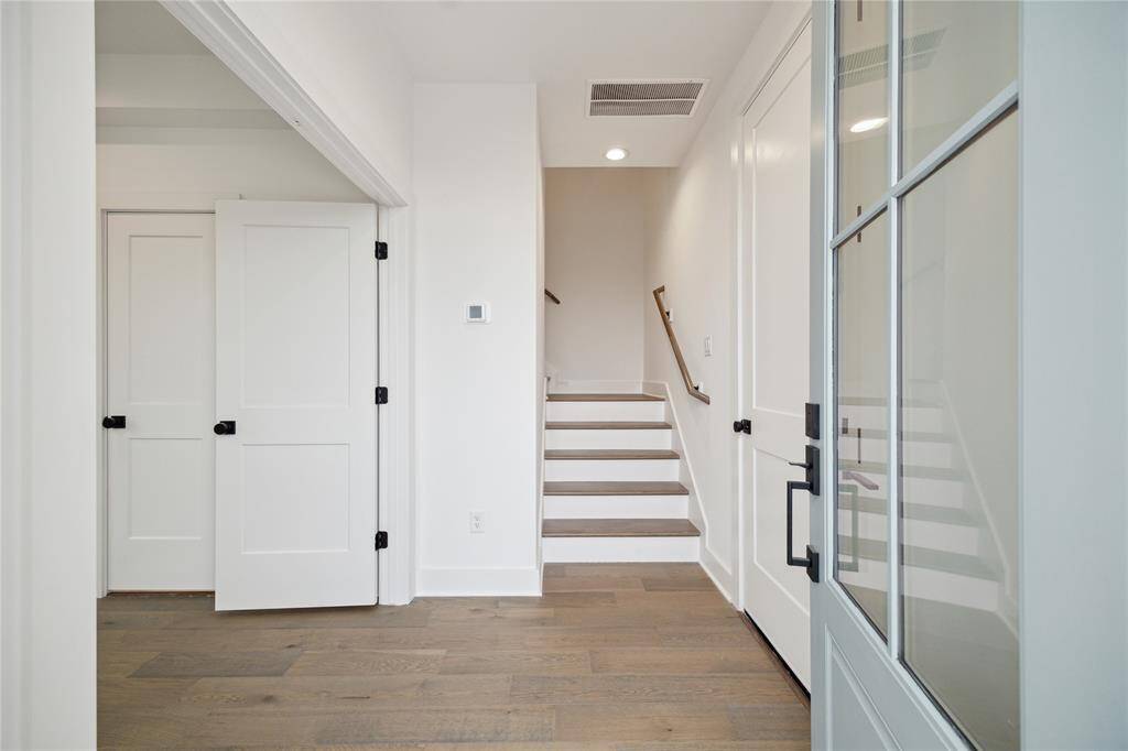 Welcoming entryway with stylish wood flooring and modern design, leading to the main living areas.