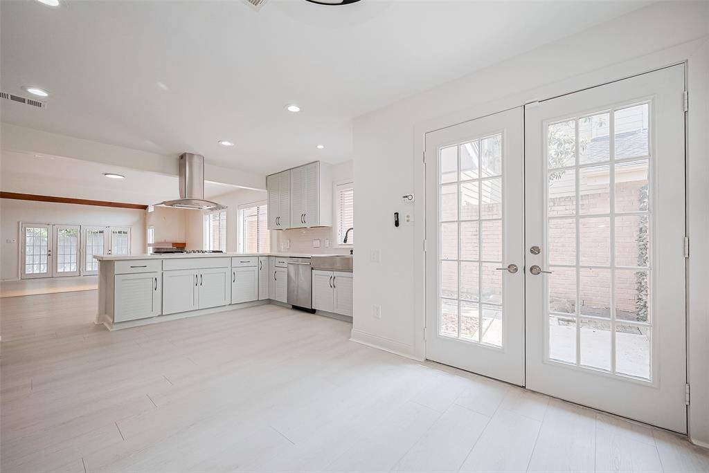 The breakfast area located in the kitchen has direct access to the side yard that wraps around to the back patio.