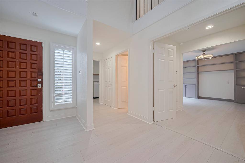 As you enter the front door, the downstairs secondary bedroom, full bathroom, and utility room are located to the left.