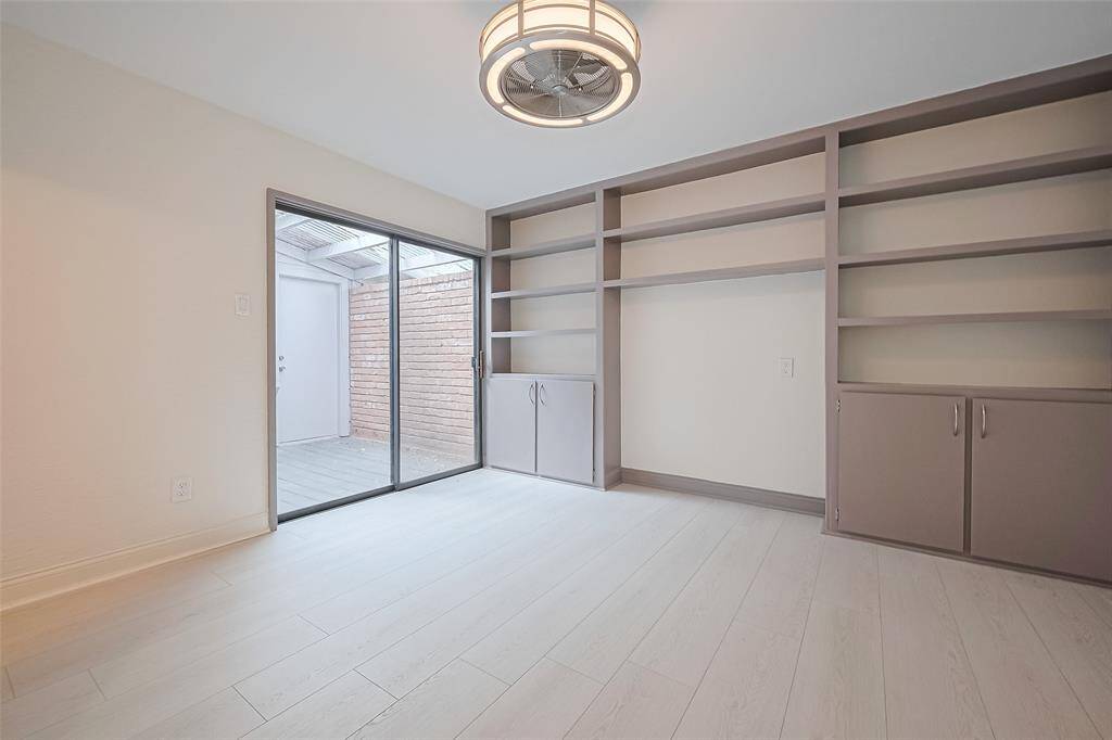 Secondary bedroom located on the first floor has access to a full bathroom, closet, and private courtyard.  Or it would be a great space for a home office!