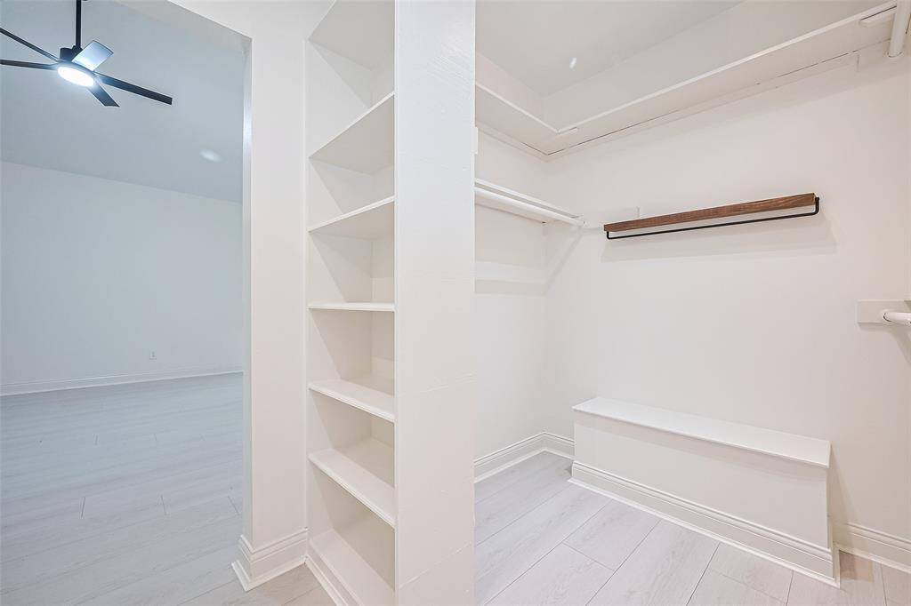 The primary closet is separated into 2 sides flanking the entryway into the primary bathroom.