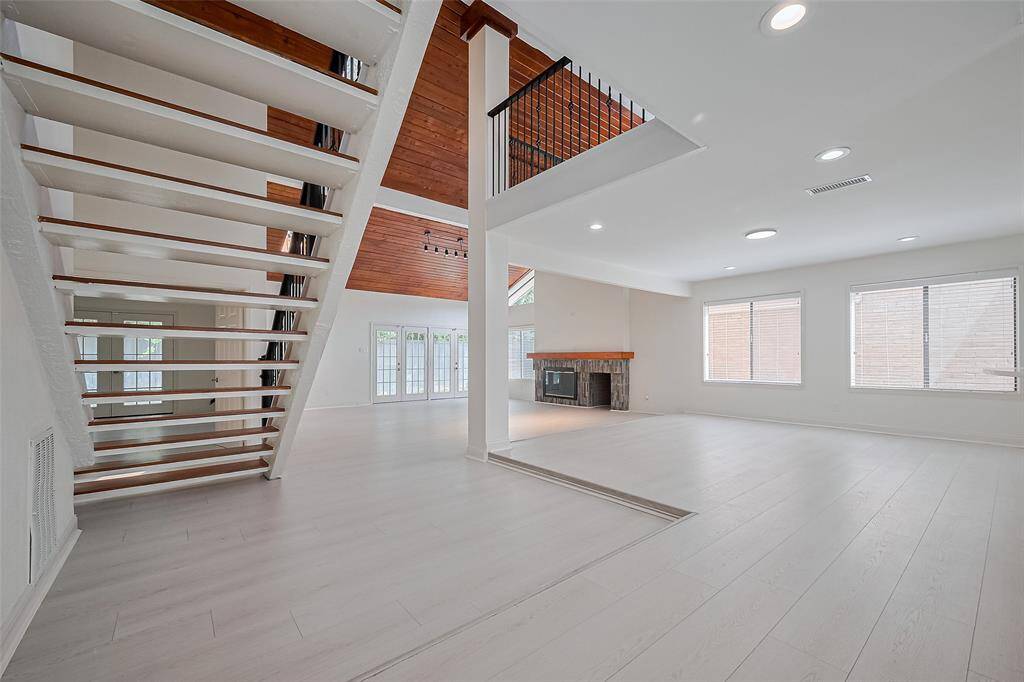 As you enter the front door, the downstairs secondary bedroom, full bathroom, and utility room are located to the left.