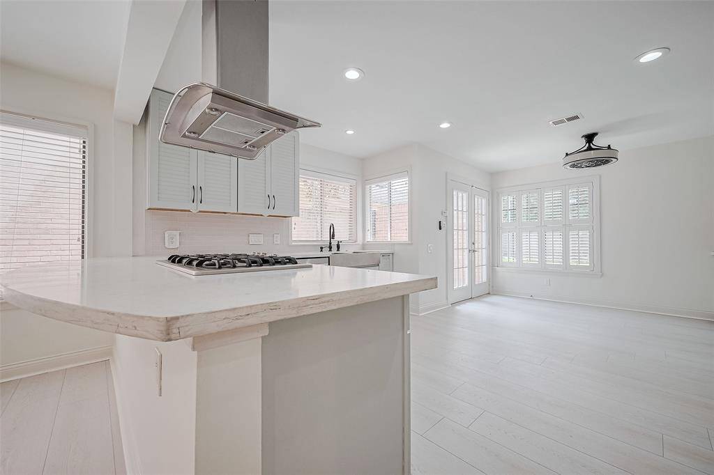 The updated kitchen features quartz countertops, stainless steel appliances and so much natural light.