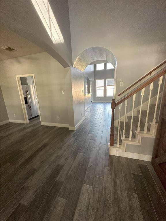 View from front door, Dining Room to left, door to kitchen. Straight ahead is the large den. To right by stairs the Utility Room